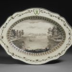Oval, cream coloured earthenware plate from the 'Frog Service', painted with a view of the lake at West Wycombe, Buckinghamshire.