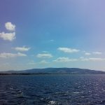 Image of The Hellespont. A hilly horizon with blue water below and blue sky above